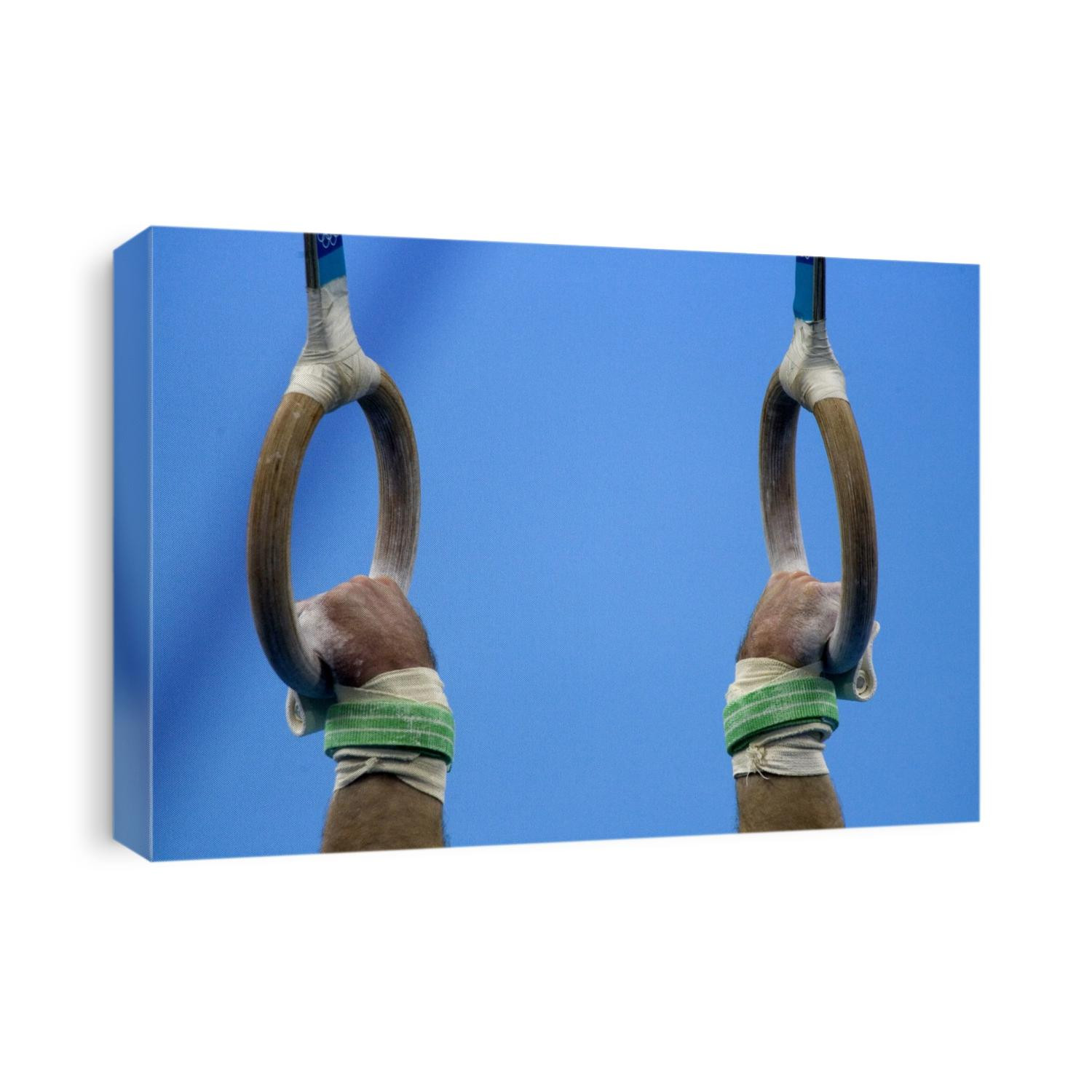 Detail of male gymnast competing on the rings