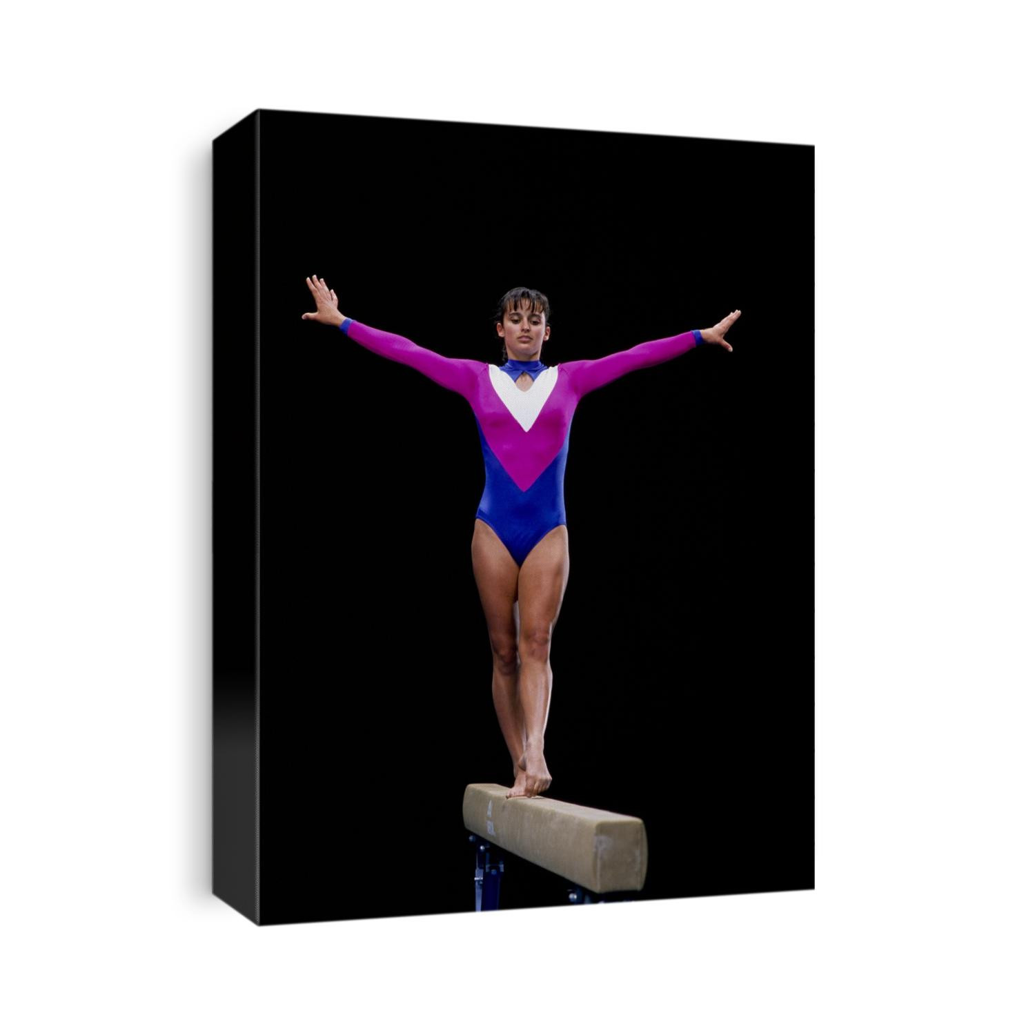 Female gymnast performing on the balance beam.