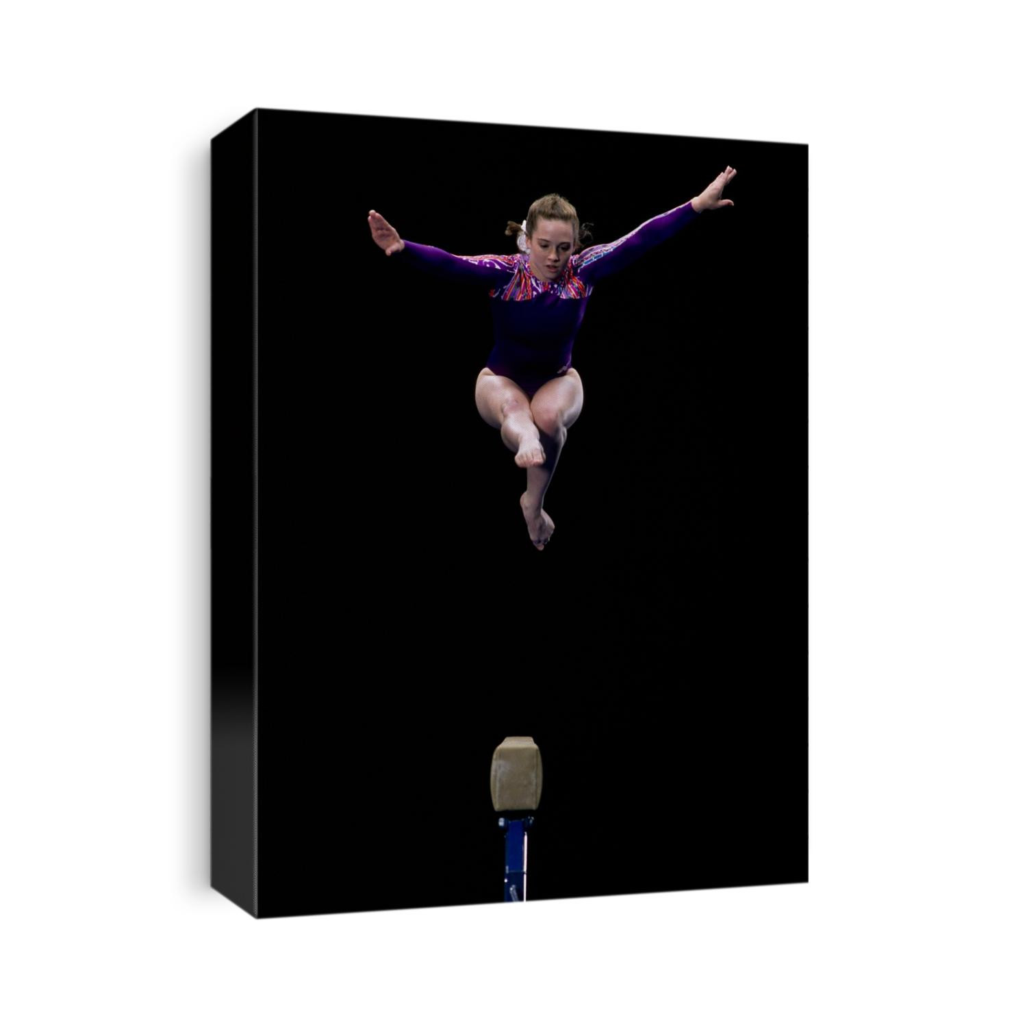 Female gymnast performing on the balance beam.