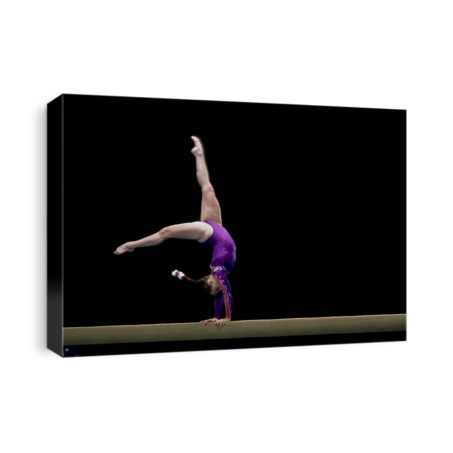 Female gymnast performing on the balance beam.
