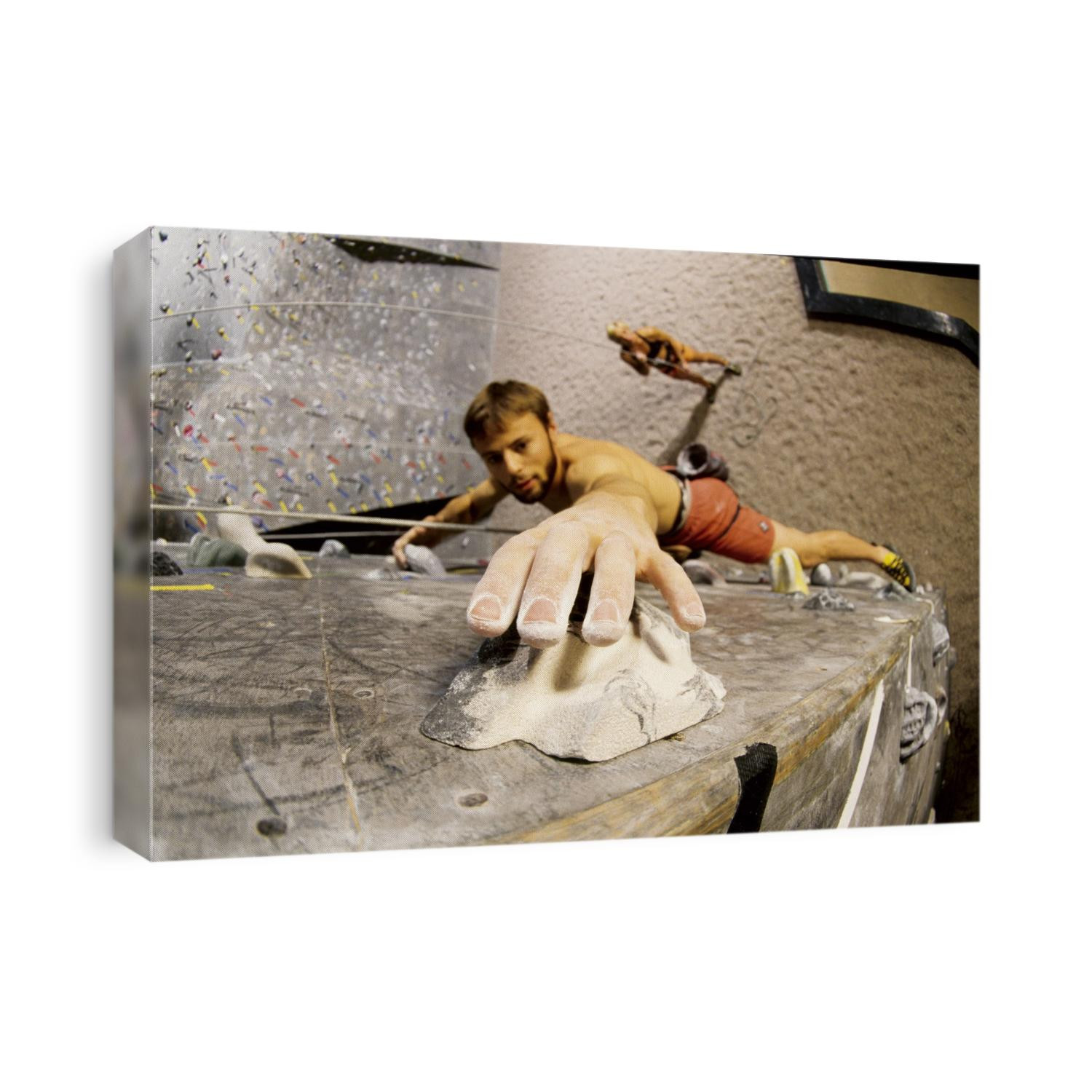 Wall climber reaches for a grip