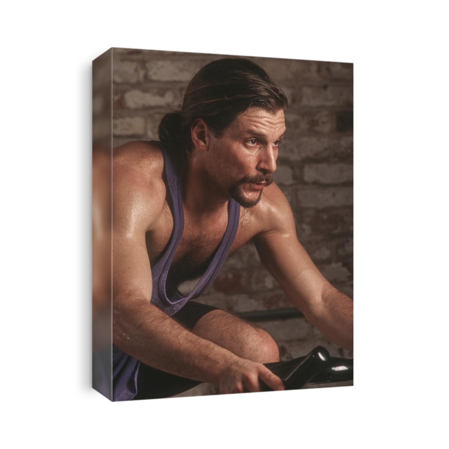 Adult male exercising on a stationary bike.