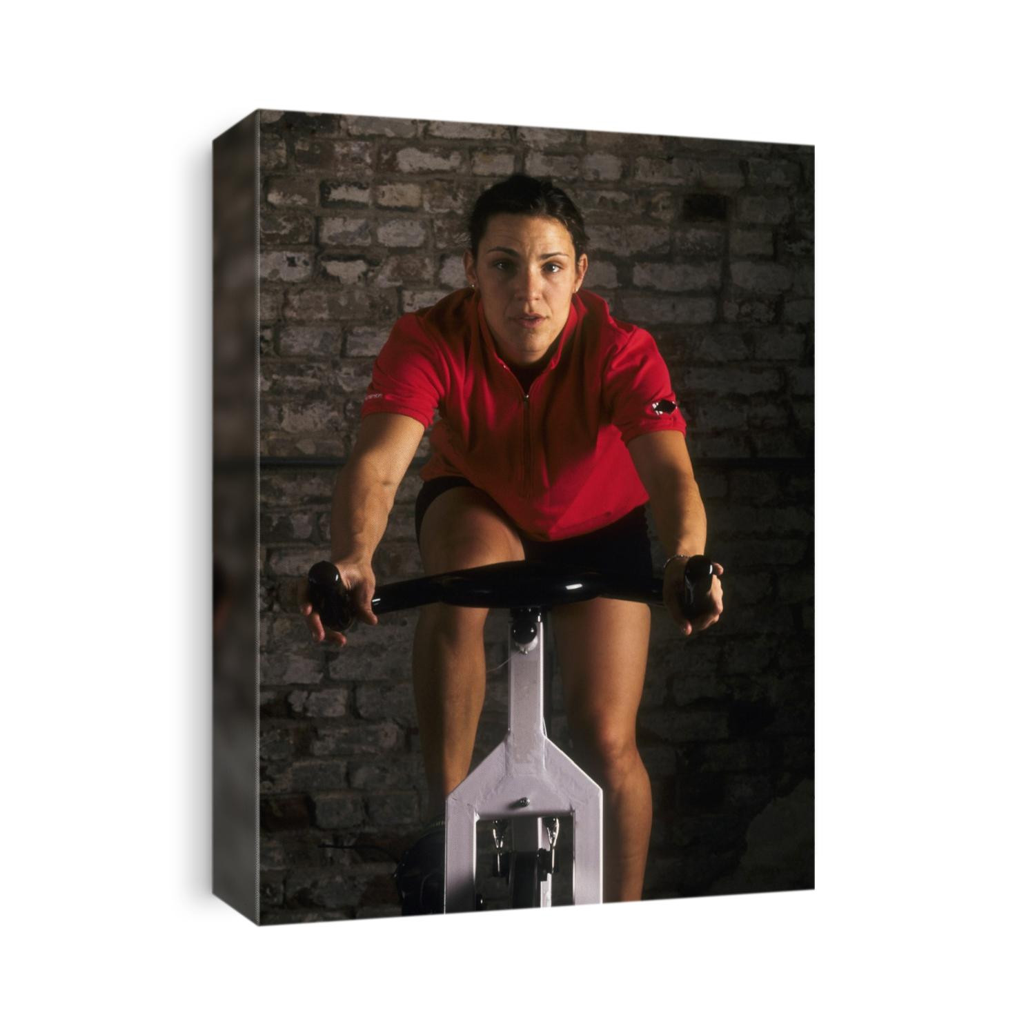 Young woman exercising on a stationary bike.