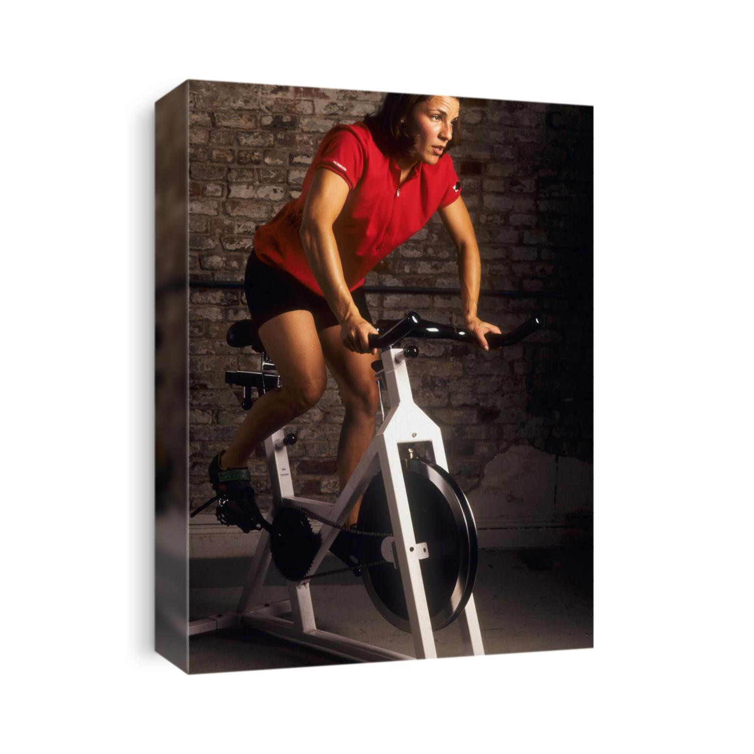 Young woman exercising on a stationary bike.