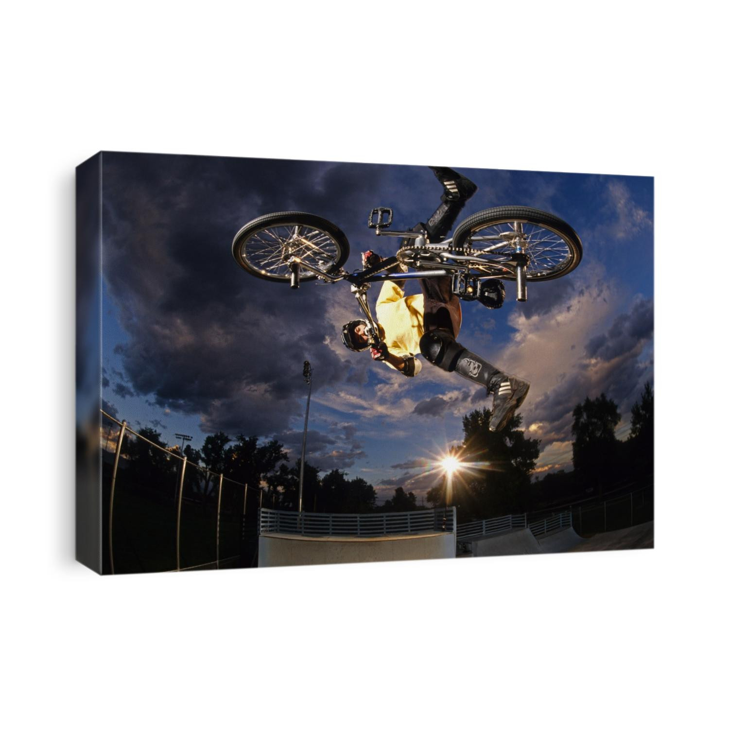 BMX cyclist flys over the vert.