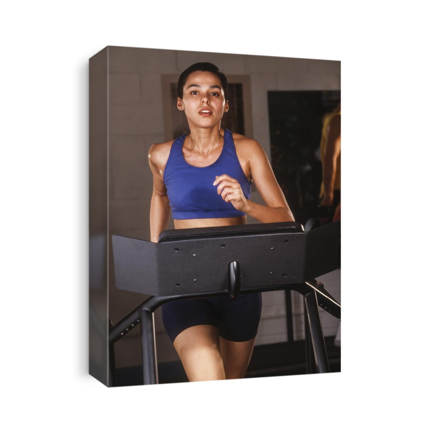 Woman exercising on a tredmill at a health club.