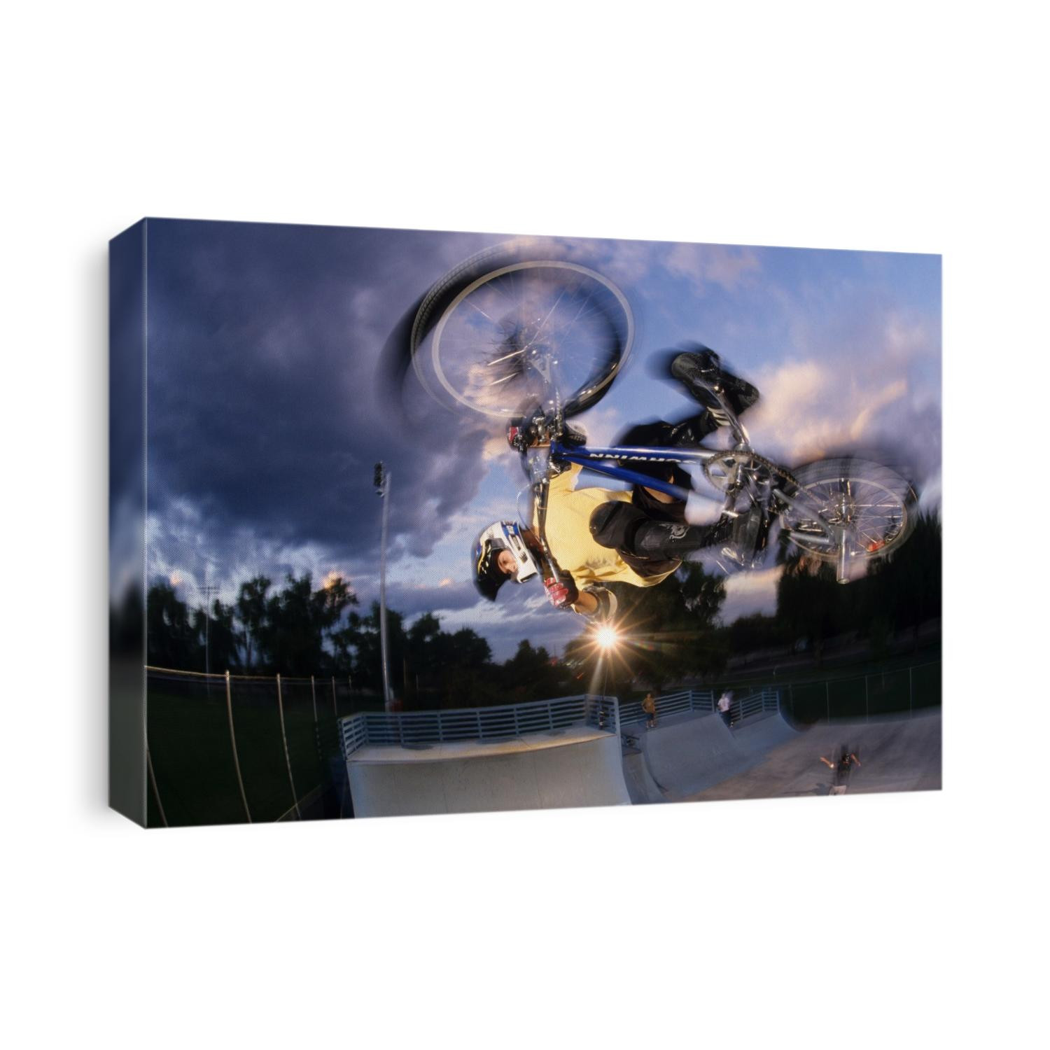 BMX cyclist flys over the vert.