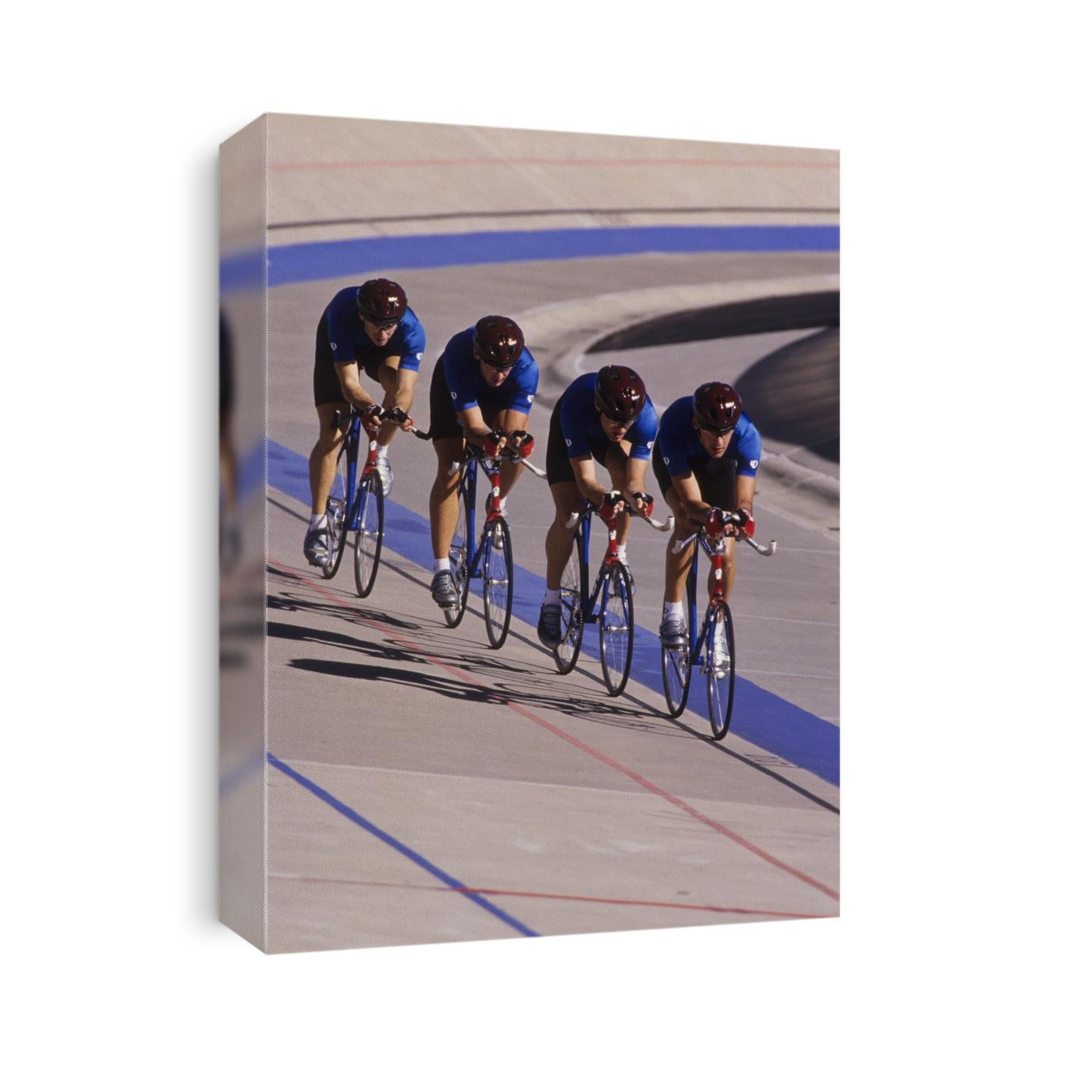 Male cycling team racing on the velodrome track.