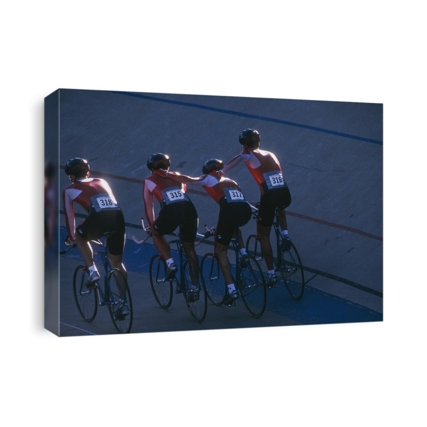 Victorious male cycling team on the velodrome.
