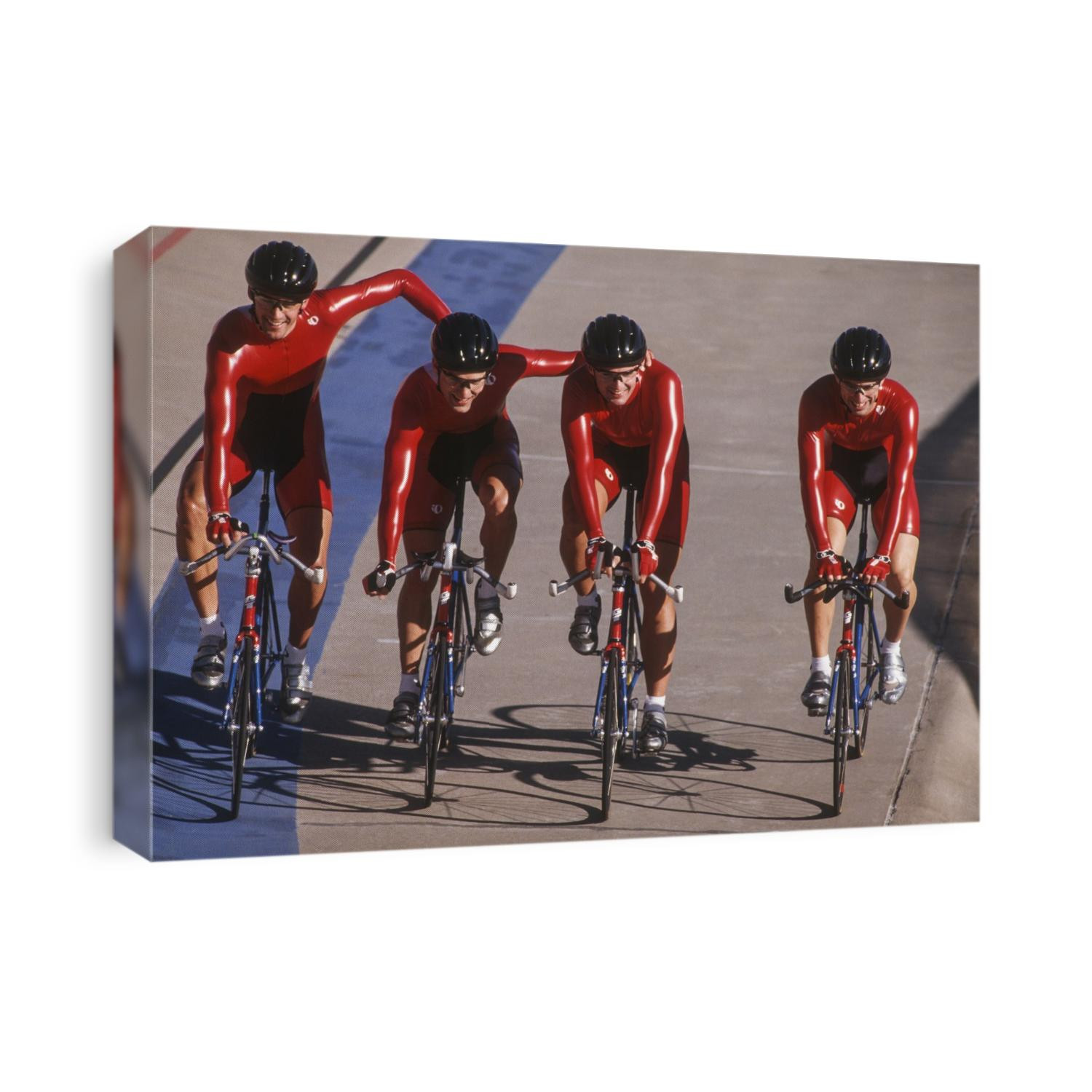 Victorious male cycling team on the velodrome.