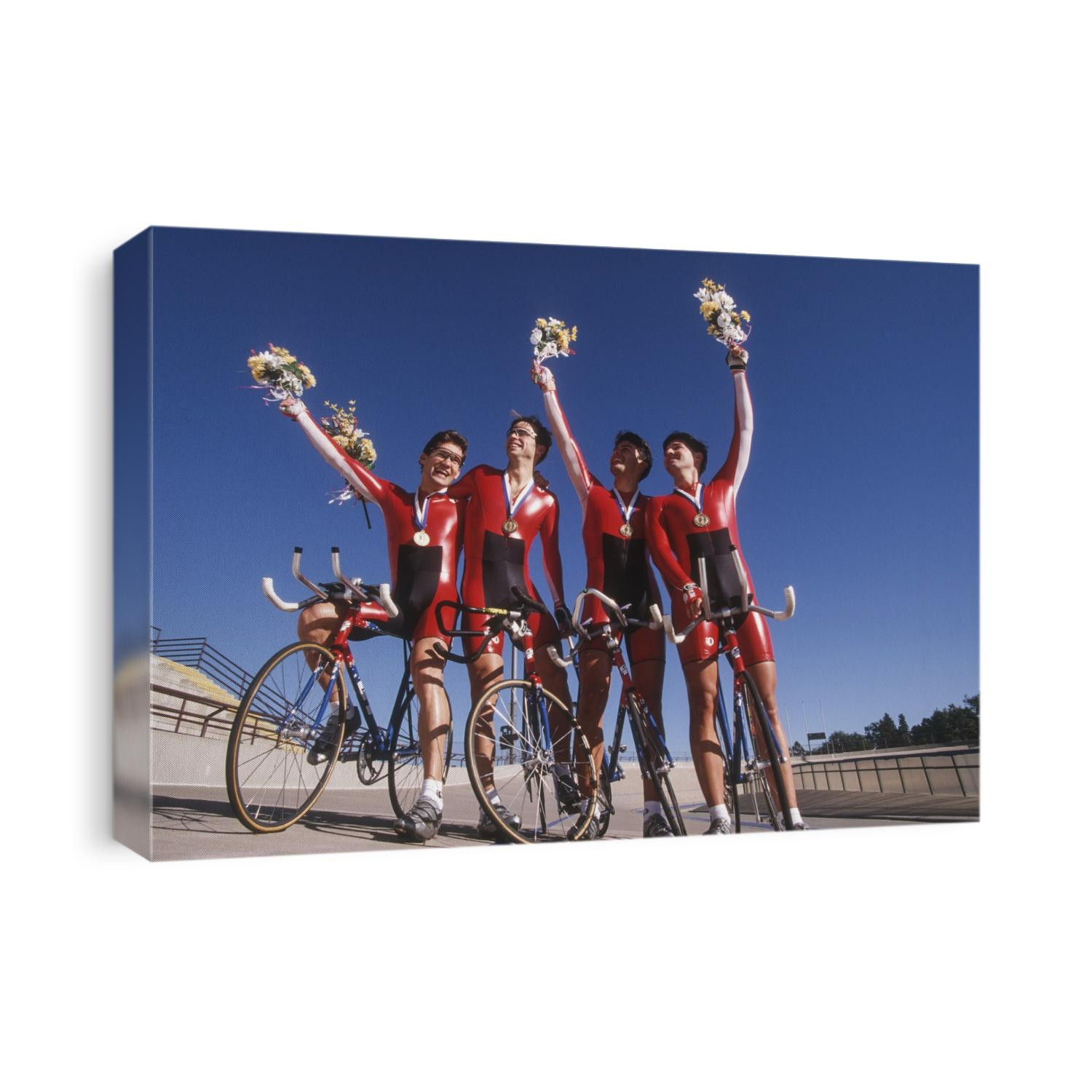 Victorious male cycling team on the velodrome.