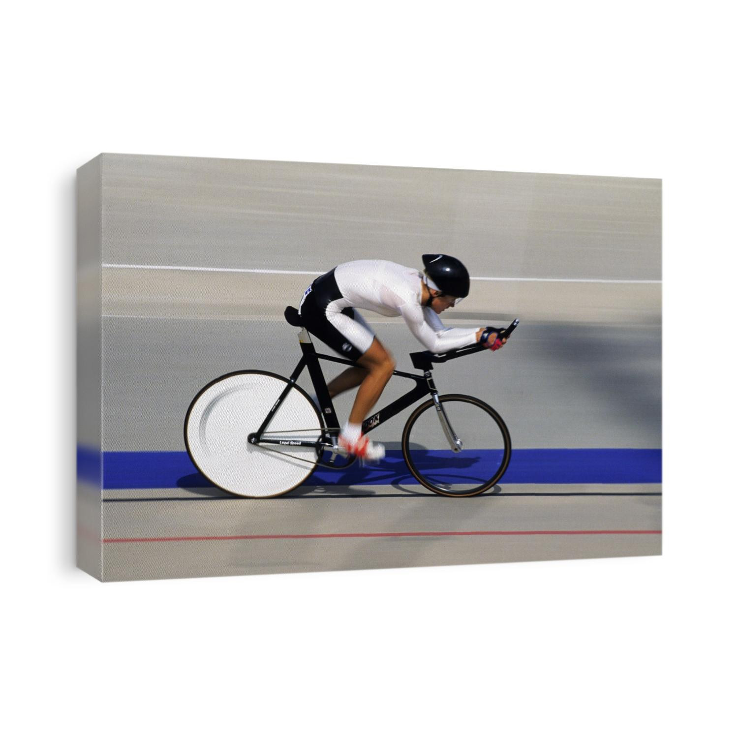 Action of female cyclist competing on the velodrome.