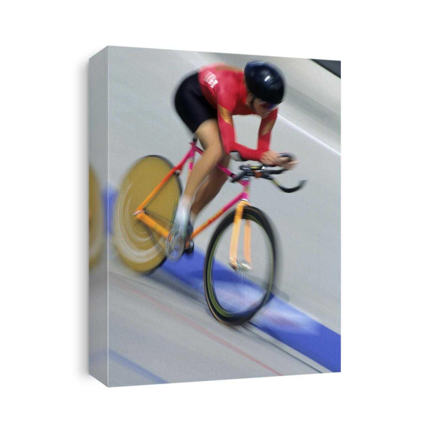 Blured action of female cyclist competing on the velodrome.