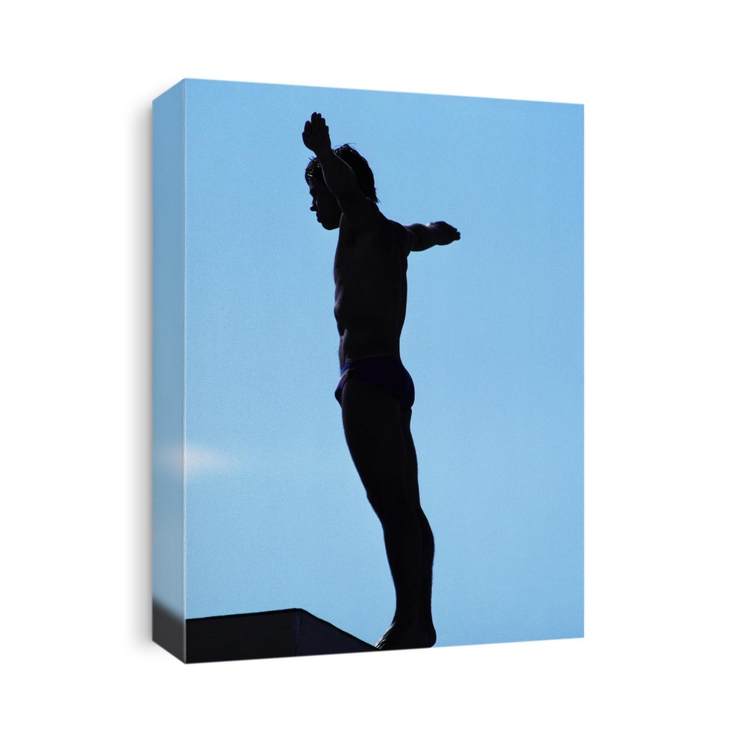 Silhouette of male diver about to dive off the 10m platform.
