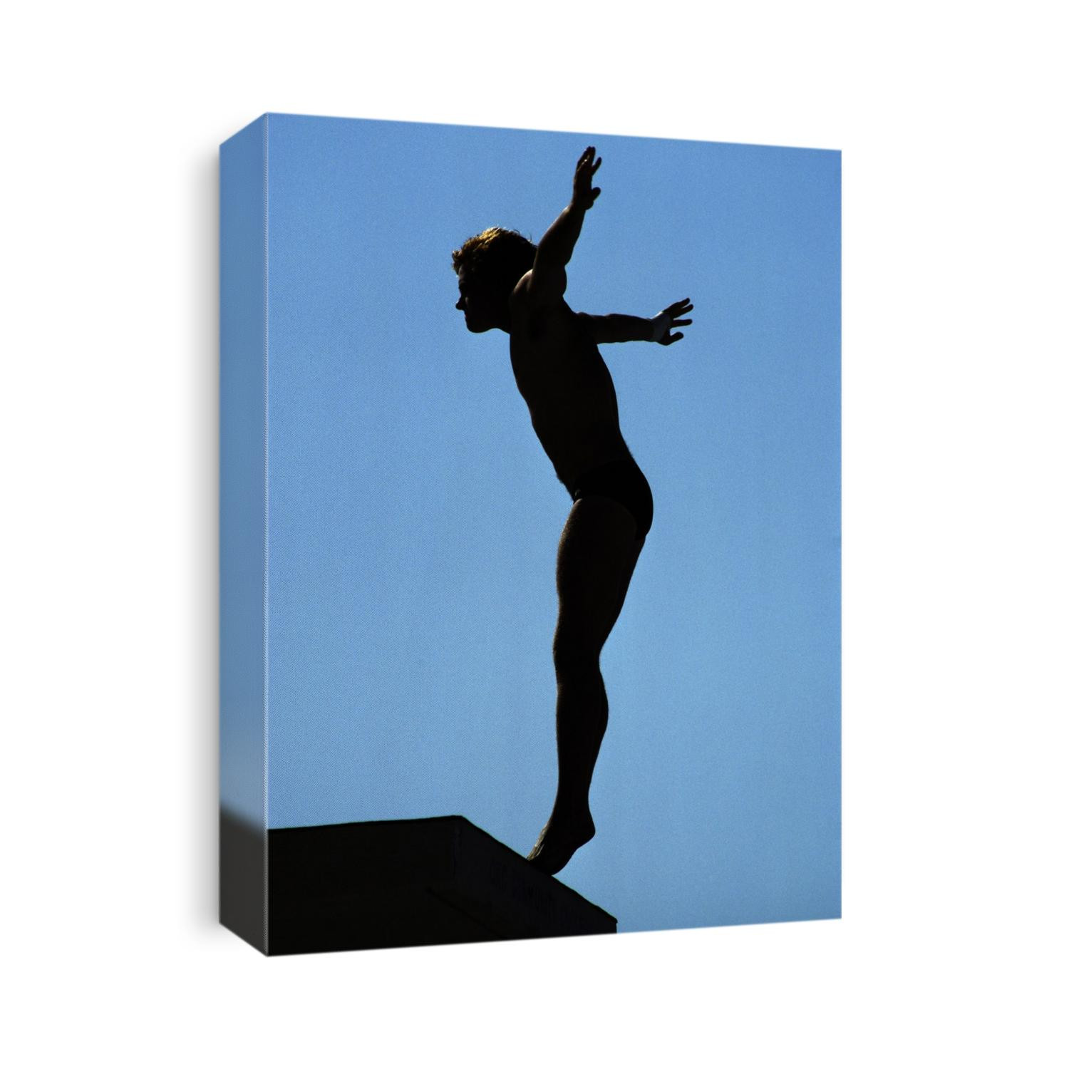 Silhouette of male diver about to dive off the 10m platform.