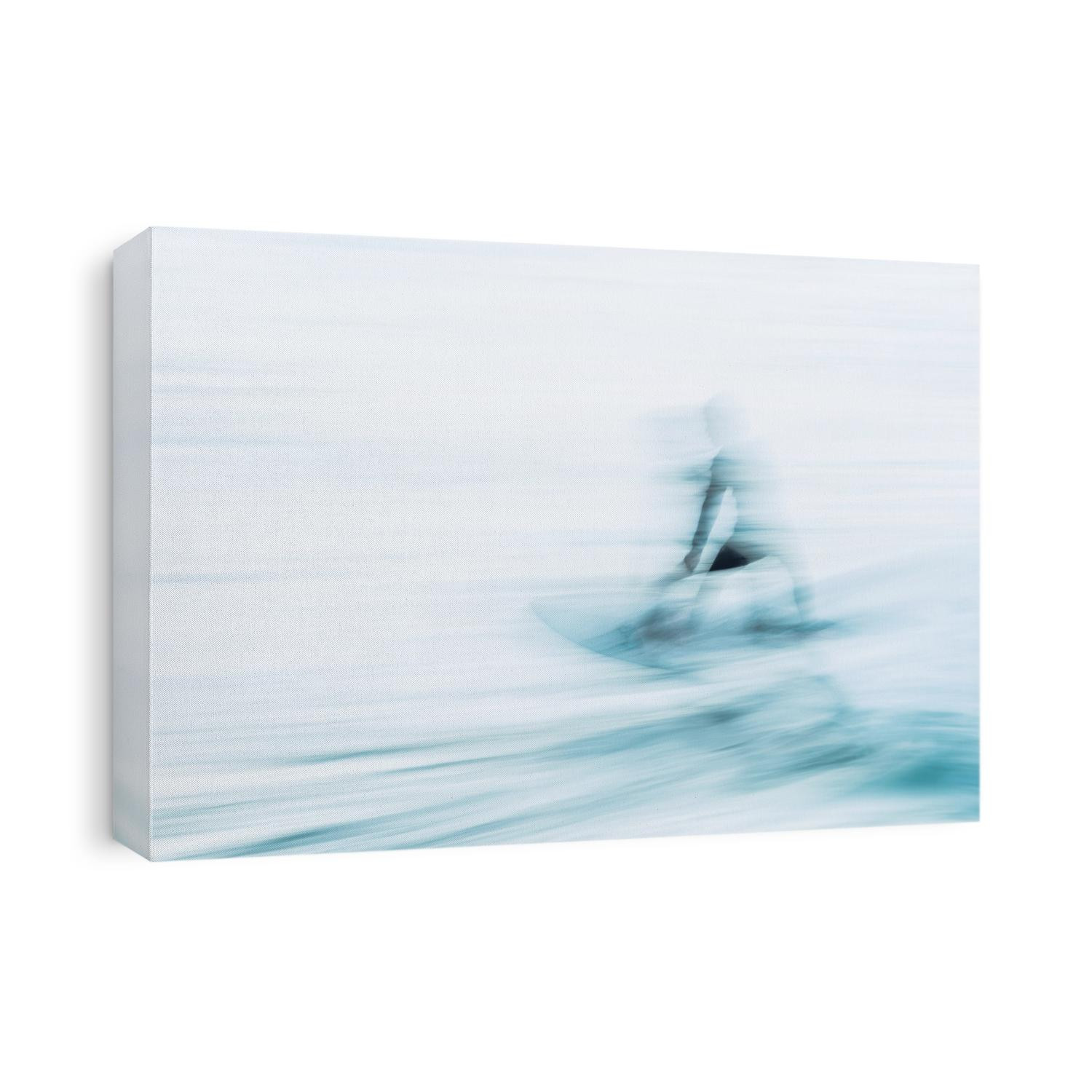 A long exposure photograph of a surfer racing by on a breaking wave