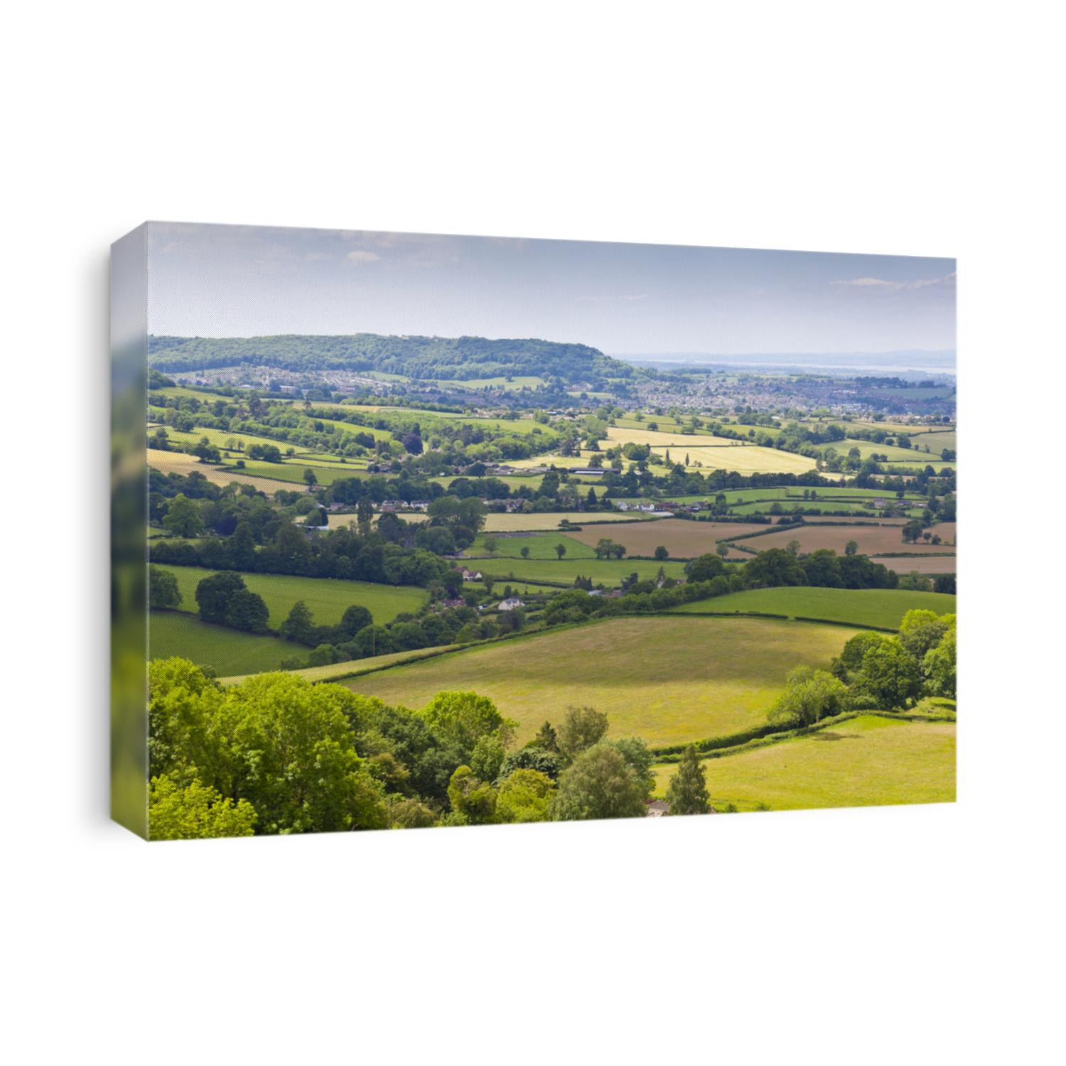 Idyllic rural view of gently rolling patchwork farmland and villages with pretty wooded boundaries, in the beautiful surroundings of the Cotswolds, England, UK.