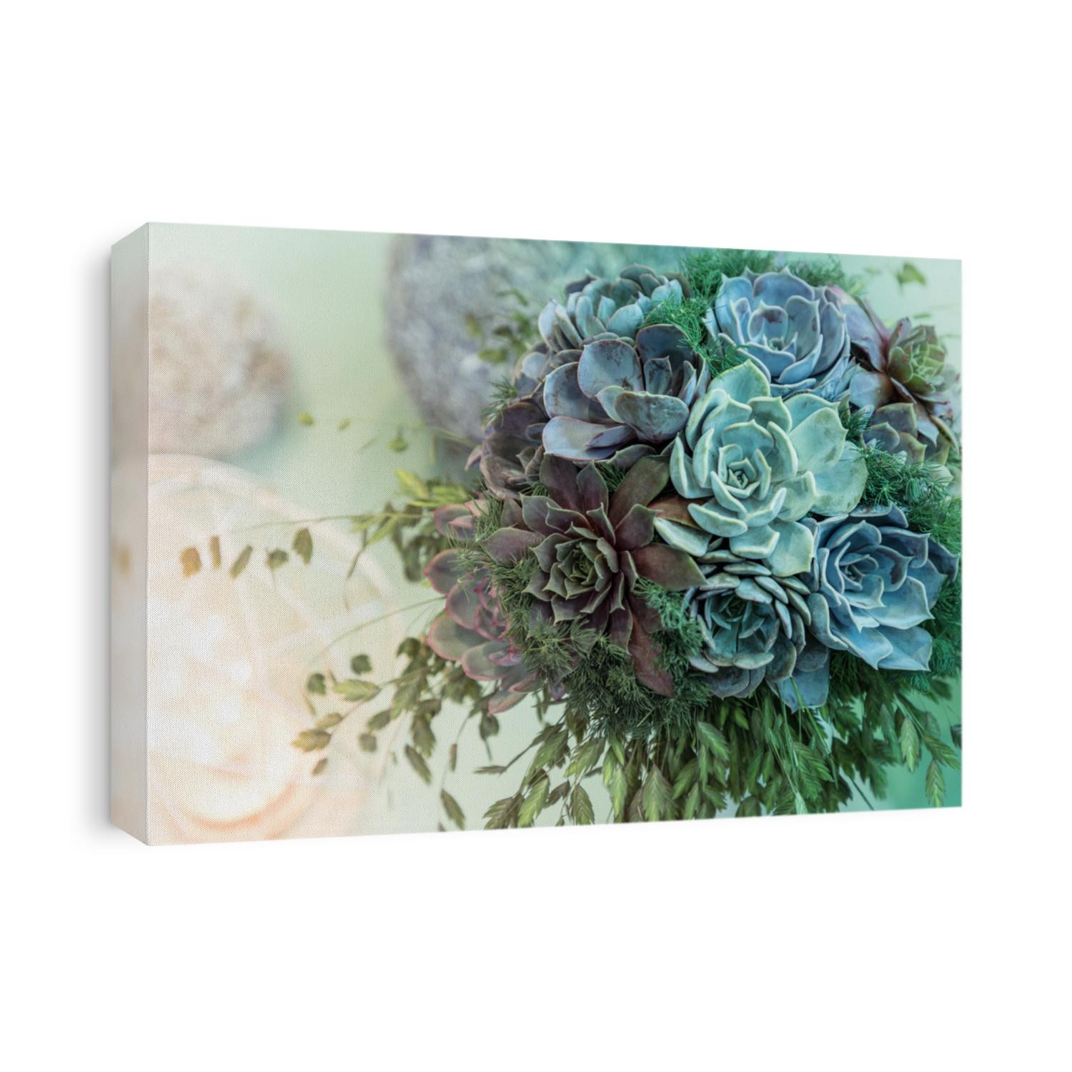 Trendy wedding bouquet made out of succulents on a pastel background