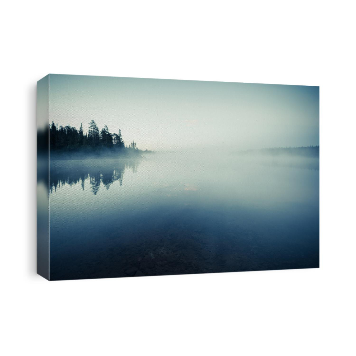 Quiet lake before dawn in the mist