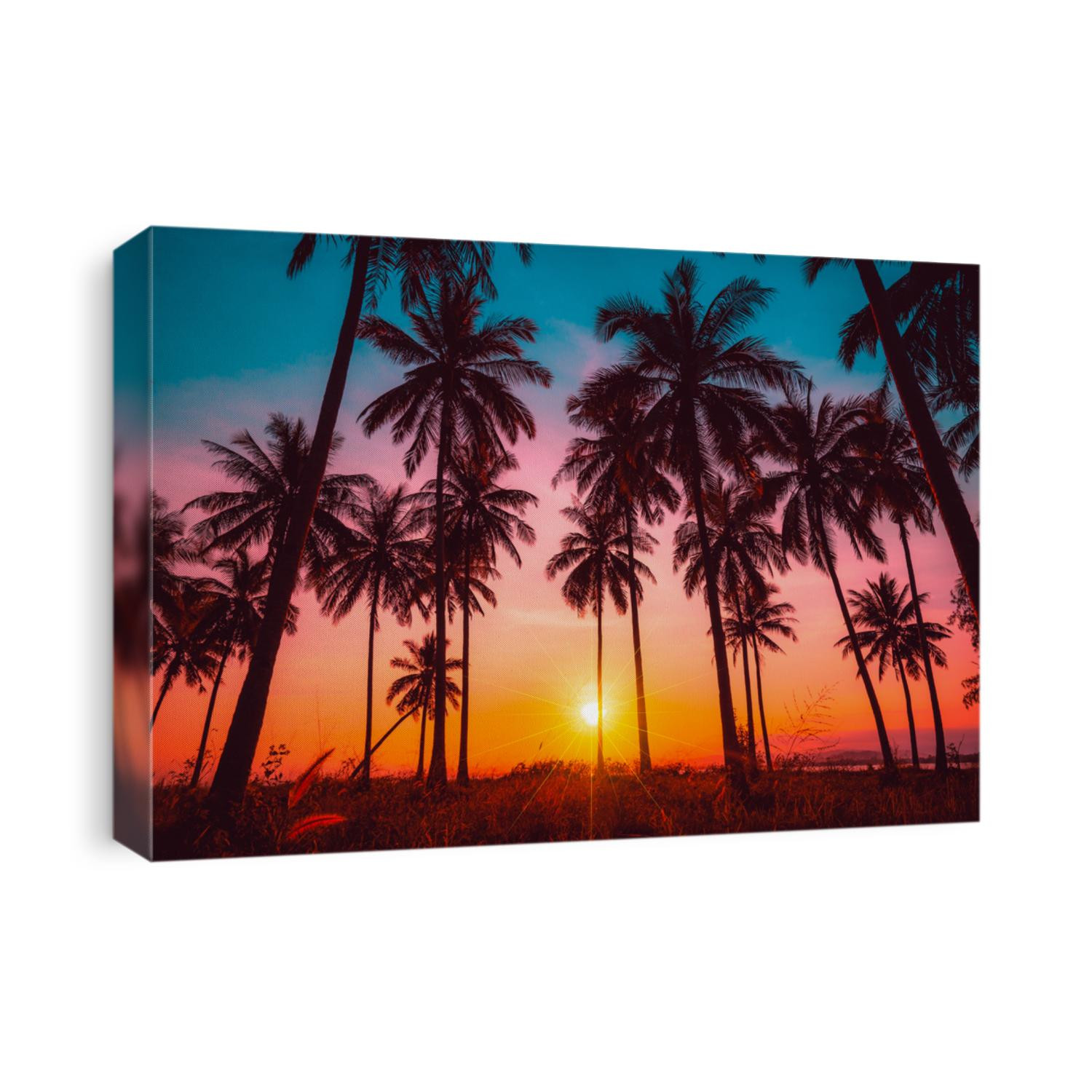 Silhouette coconut palm trees on beach at sunset. Vintage tone.