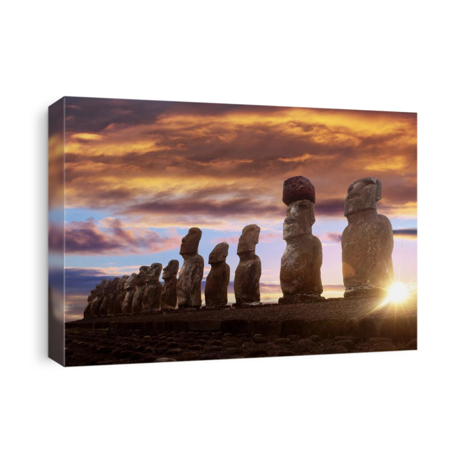 Standing moai in Easter Island against rising sun and orange sky