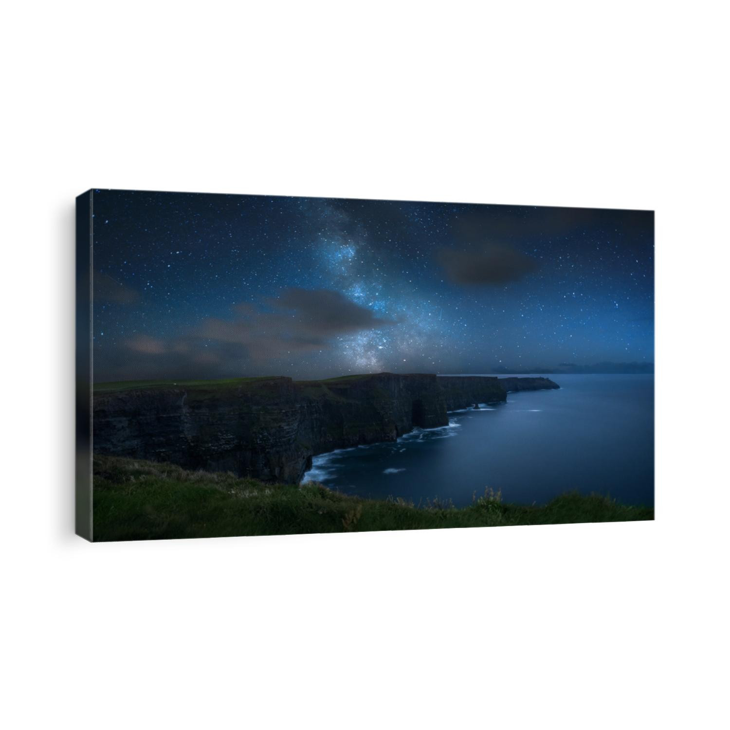 Milky way over dramatic Cliffs of Moher and wild Atlantic Ocean, Ireland.