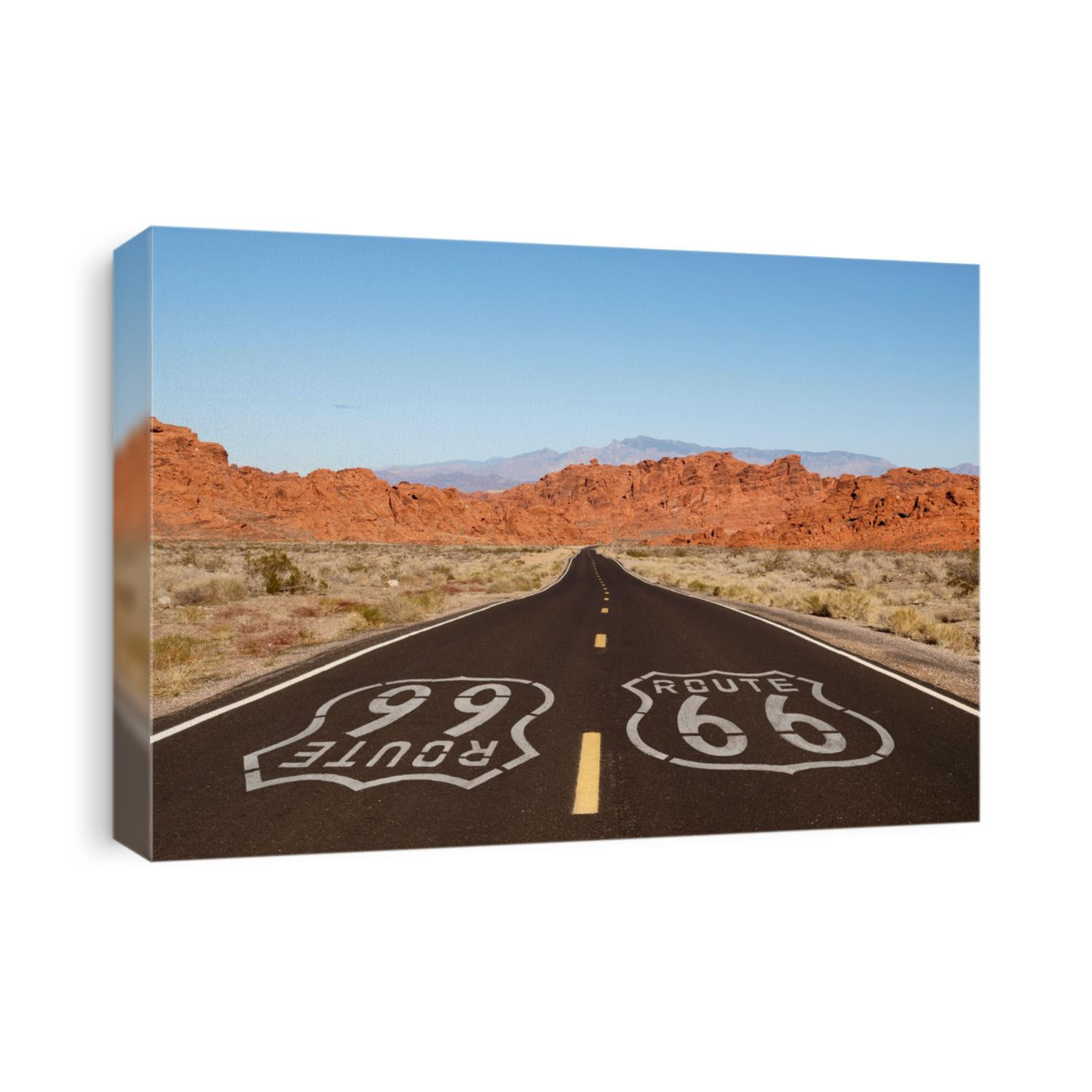 Route 66 pavement sign with Mojave desert red rock mountains.