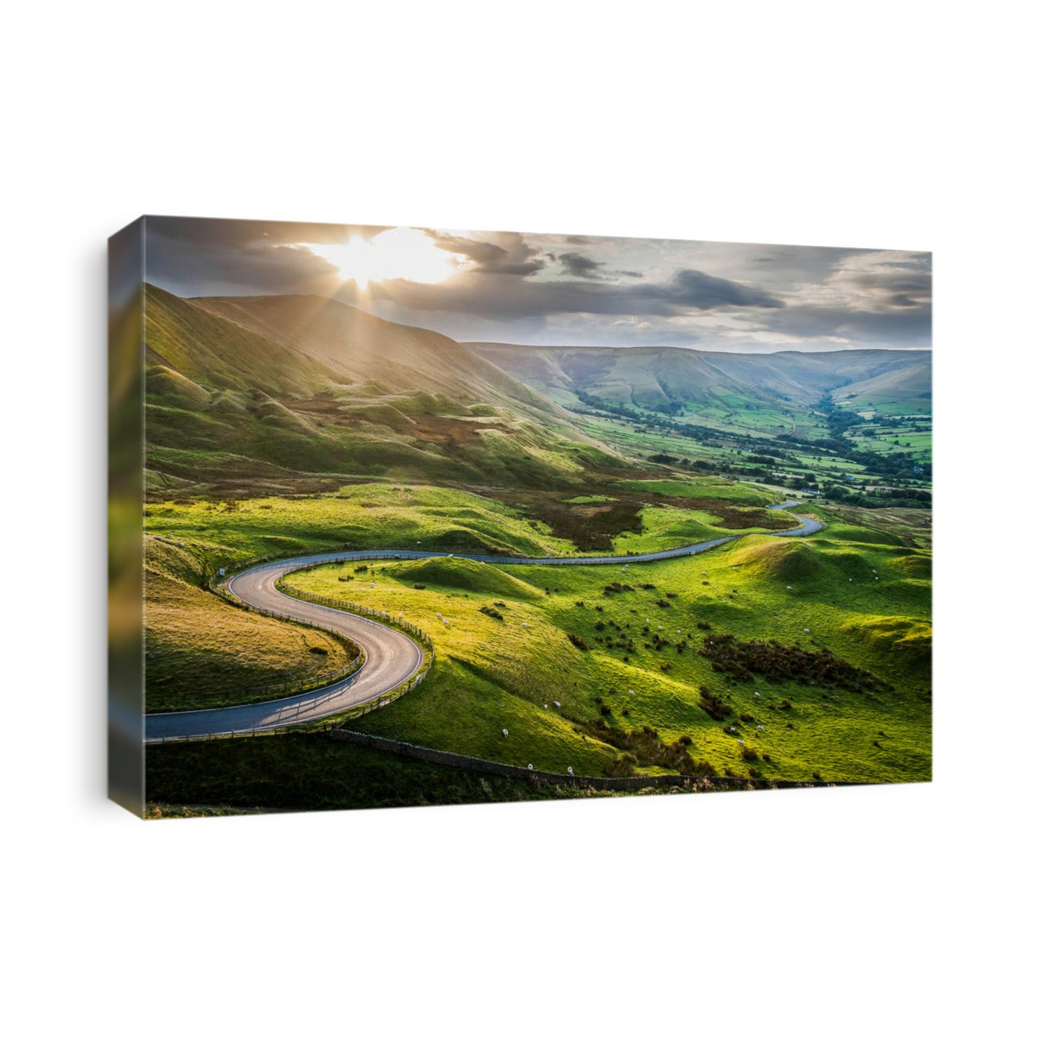Sunset at Mam Tor, Peak District National Park, with a view along the winding road among the green hills down to Hope Valley, in Derbyshire, England.