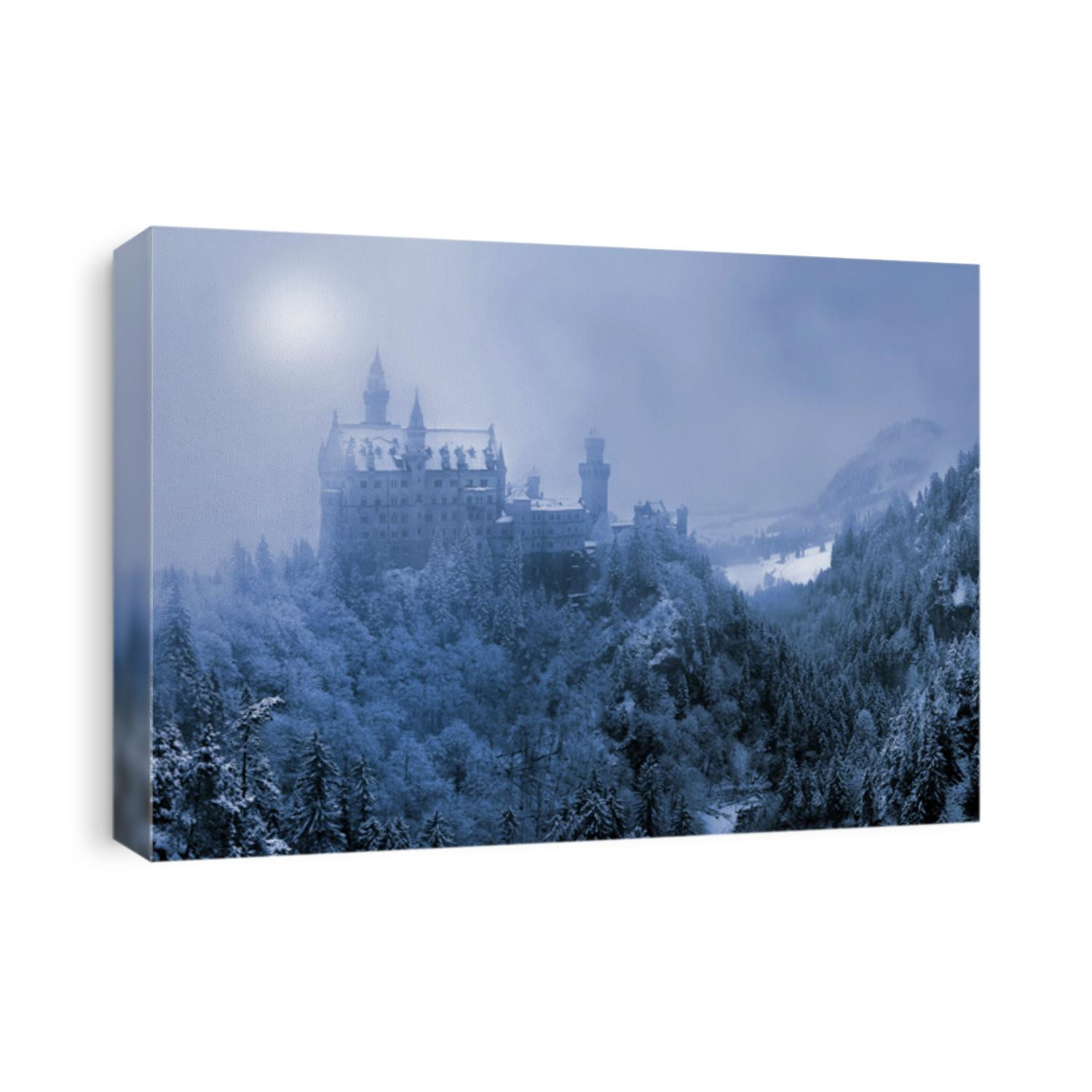 The famous Neuschwanstein Castle in the background of snowy mountains and hills in in the light of the sun through a snowstorm and blizzard. Germany, Europe