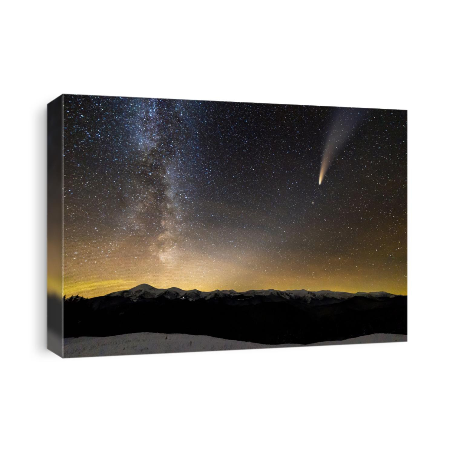 Surreal view of night in mountains with starry dark blue cloudy sky and C/2020 F3 (NEOWISE) comet with light tail.