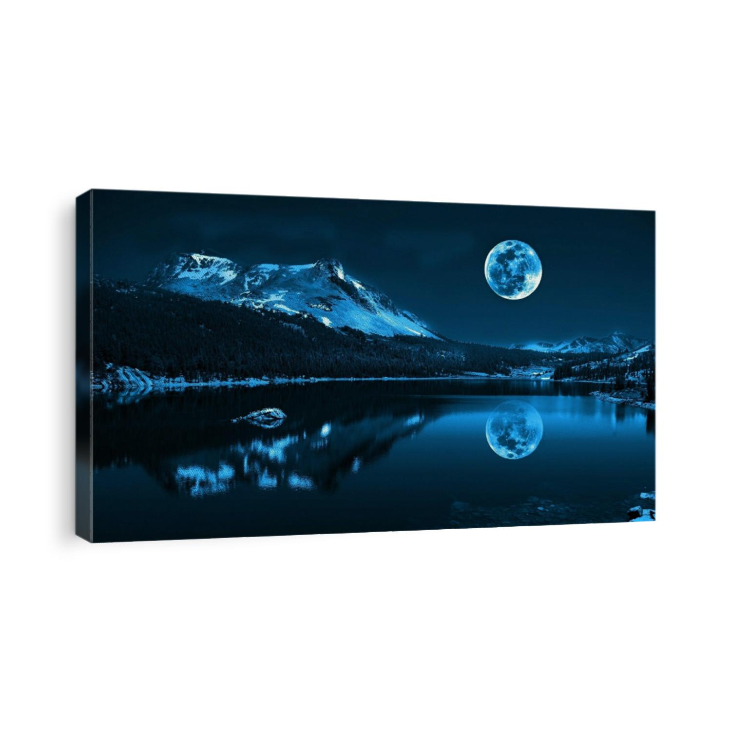 Full moon rising over empty lake near the big mountain at night with copy space. A night panorama view of crescent moon in the night sky at midnight. Moonlight romantic landscape background concept.