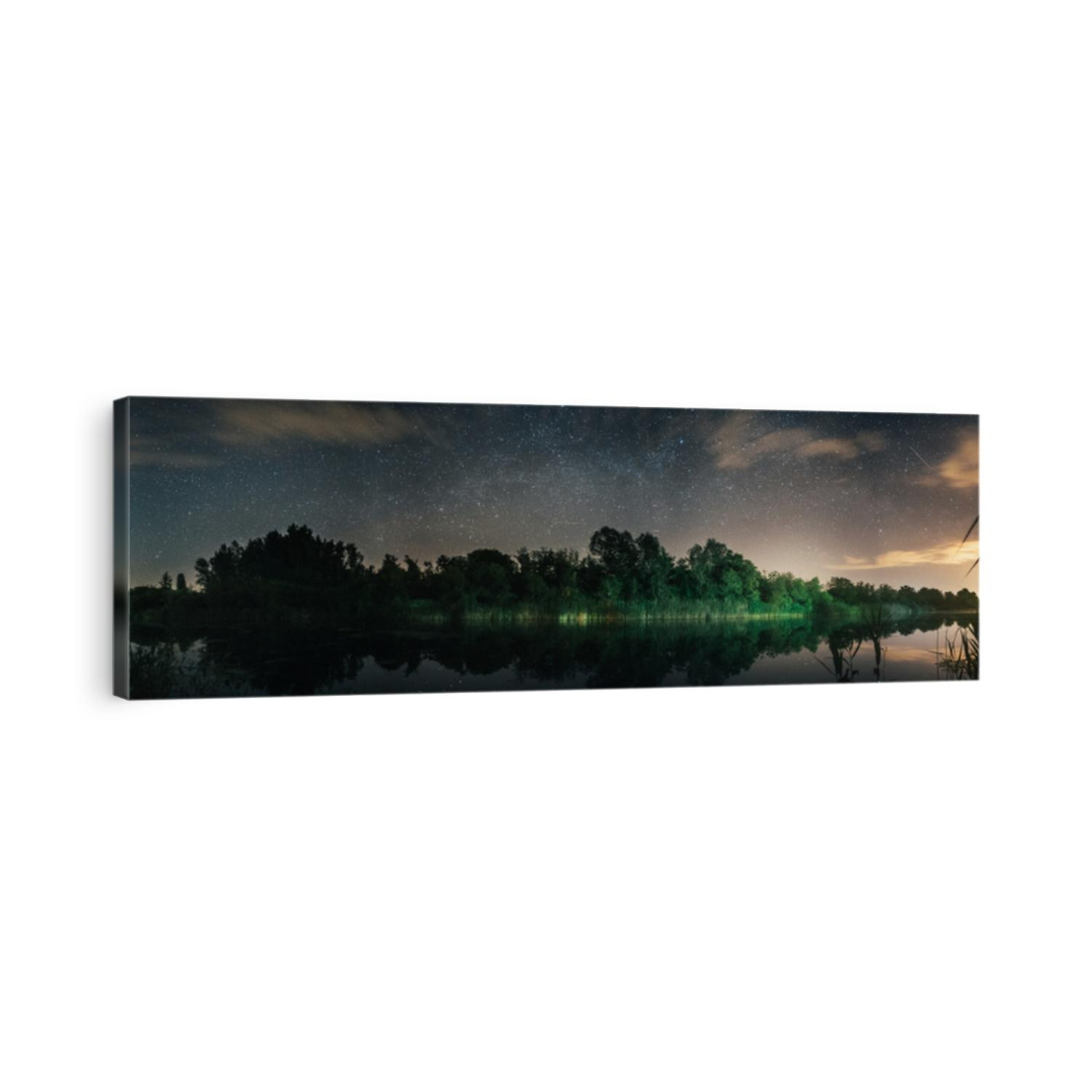 beautiful panoramic view on lake and forest at night looking at stars and milky way passing on center